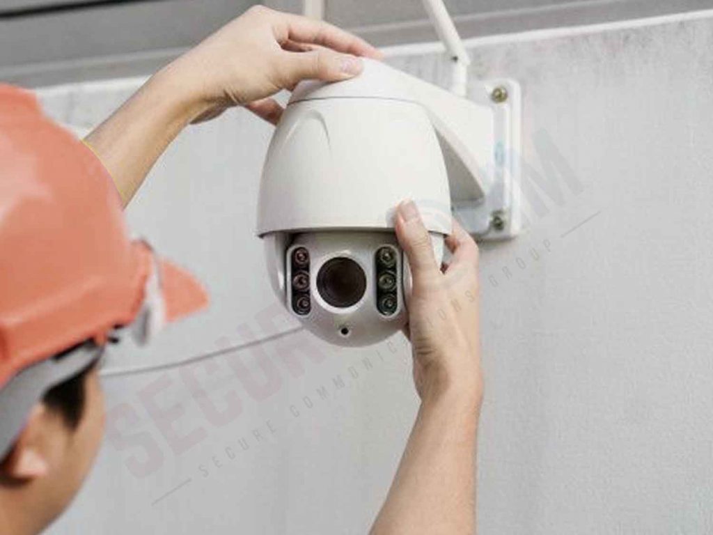 Technician installing a PTZ camera, illustrating the complexity and potential challenges associated with these advanced security systems.